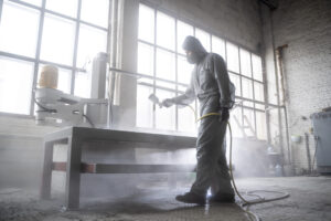 man spraying powder paint full shot scaled 1 - Pilot India